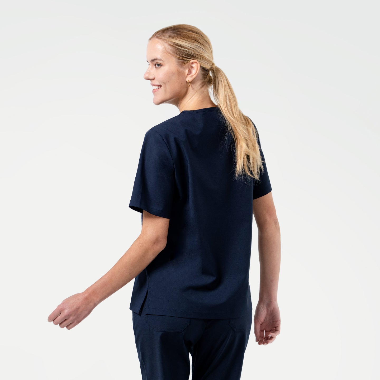 Image of Back view of the Eco Navy scrub top with matching scrub pants for a polished professional style.